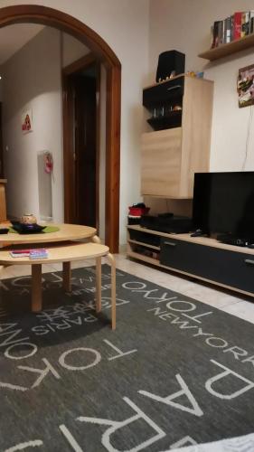 a living room with a table and a flat screen tv at •Budget travellers •Great location in Athens