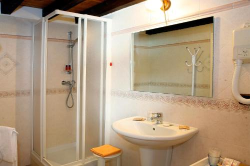 a bathroom with a sink and a shower at Les Combes in La Salle