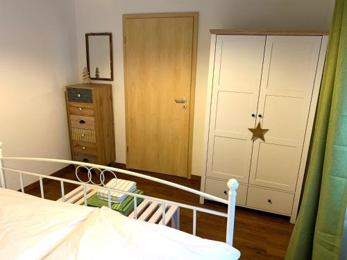 a bedroom with a bed and a closet and a door at Villa Ammonit in Pottenstein