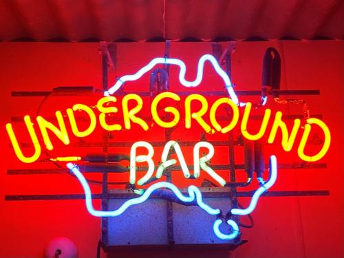 a neon sign that reads underground ground bar at White Cliffs Underground Motel in White Cliffs