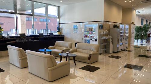 a lobby with chairs and tables in a store at Toyoko Inn HOSPITAL INN Dokkyo Medical University in Mibu