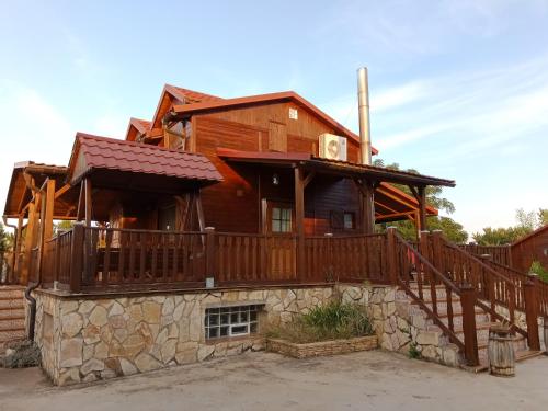 a log cabin with a porch and a deck at Casa Telma y Hugo in Alcañiz