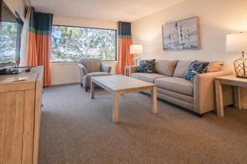a living room with a couch and a table at Bay Club of Sandestin in Destin