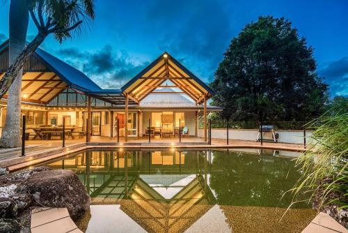 a house with a pool in front of it at Coorabell Estate in Coorabell Creek