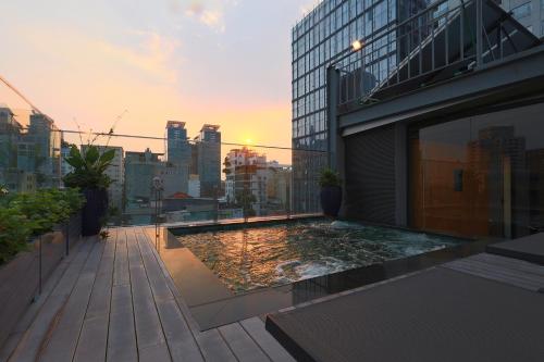 a rooftop swimming pool on the roof of a building at CHERRY BOUTIQUE HOTEL in Ho Chi Minh City