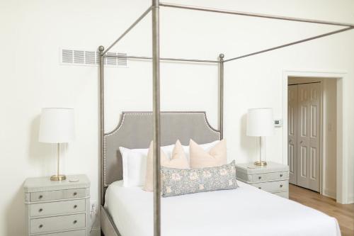 a bedroom with a canopy bed with two night stands at Fairville Inn in Chadds Ford