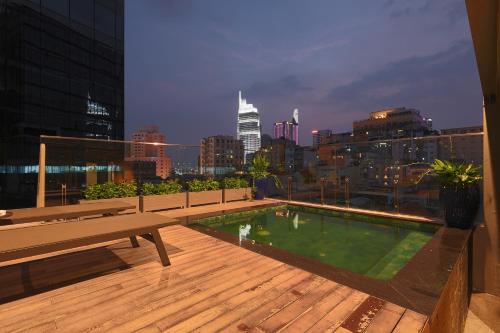 a rooftop pool with a view of a city at CHERRY BOUTIQUE HOTEL in Ho Chi Minh City