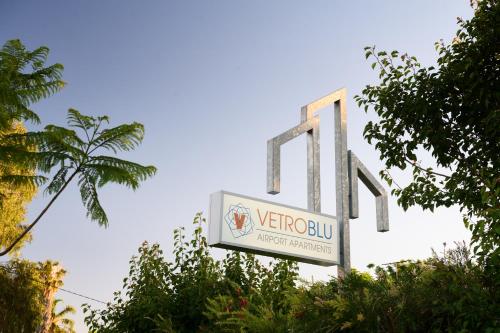 a sign for a verizon building with a palm tree at Airport Apartments by Vetroblu in Perth