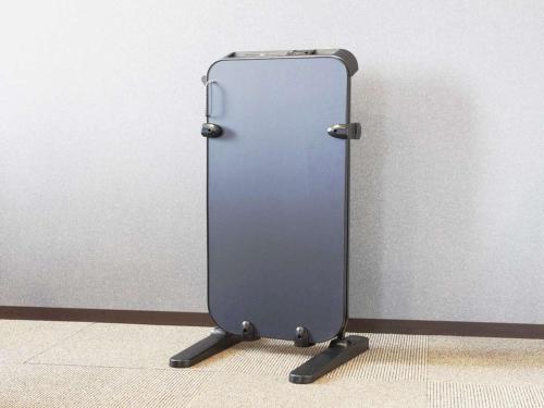 a metal refrigerator sitting on the floor next to a wall at Hotel Mystays Nagoya Nishiki in Nagoya