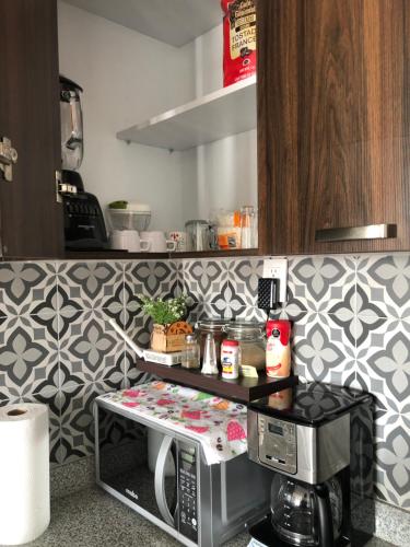 a kitchen with a microwave oven in a kitchen at Departamento *MUNDO VIAJERO* Guadalajara in Guadalajara