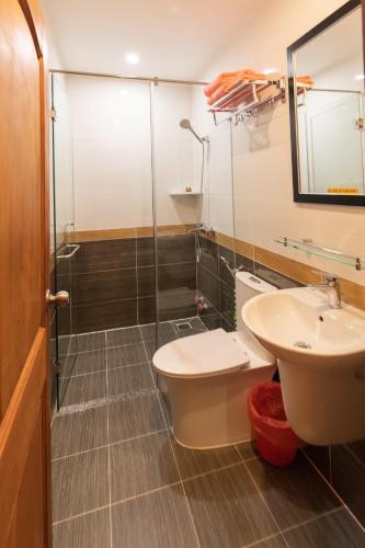 a bathroom with a shower and a toilet and a sink at 26 Topaz Hotel in Vung Tau