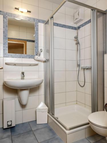 a bathroom with a shower and a sink and a toilet at Haus Seeblick Steuerbord in Insel Poel