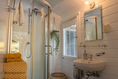 a bathroom with a sink and a shower at OTRO Curaçao - Urban Oasis in Otrobanda in Willemstad