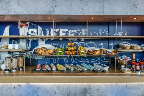 a shelf with shoes and other items on it at Ibis budget Hamburg City Ost in Hamburg