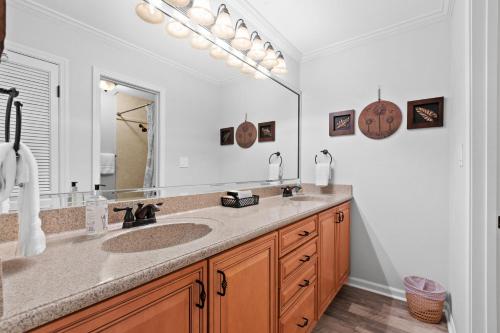a bathroom with a sink and a large mirror at Seascape Lakefront Villas 232 in Destin