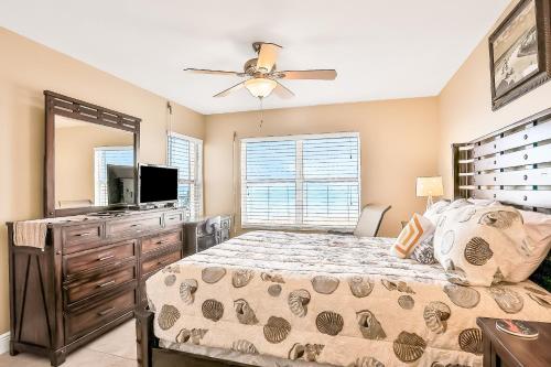 a bedroom with a bed and a ceiling fan at Sand and Sea Enjoyment Retreat in Ormond Beach