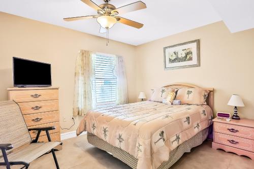a bedroom with a bed and a ceiling fan at Sand and Sea Enjoyment Retreat in Ormond Beach
