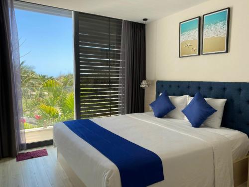 a bedroom with a large bed and a large window at Oceanami Villas & Beach Club Long Hai at 1, 3, 4 Bedroom & 5, 6 Bedroom Beachfront private pool in Long Hai