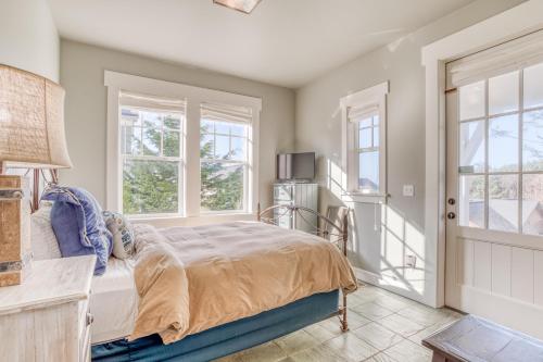 a bedroom with a bed and two windows at Mill House in Lincoln City