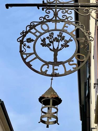 a sign on the side of a building with a bell at Antica locanda al Gelso in Monfalcone