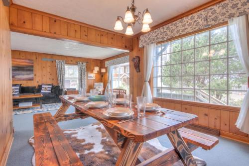 a dining room with a table and a large window at The Nordic House in the Cove - Meredith Lodging in Seaside