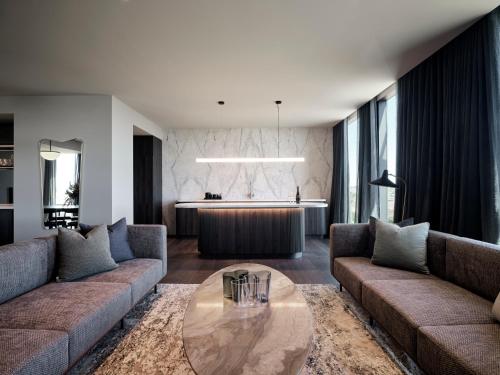 a living room with a couch and a table at Hyatt Place Melbourne Caribbean Park in Scoresby
