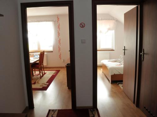 a room with a door open to a room with a bedroom at Hotel Restauracja LORENZO in Stopnica