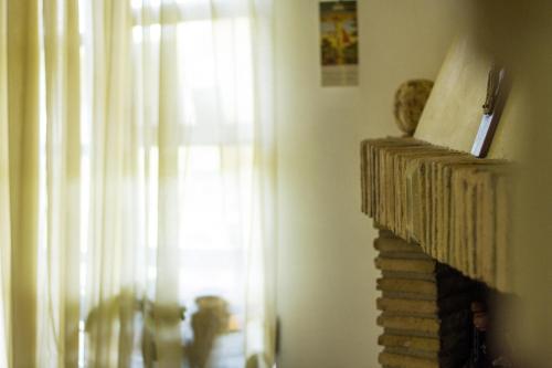 a living room with a fireplace and a window at Casa Dell'Arciprete B&B in Arielli