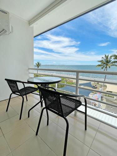 a balcony with a table and chairs and a view of the ocean at Sailors Beach Fiji in Nadi