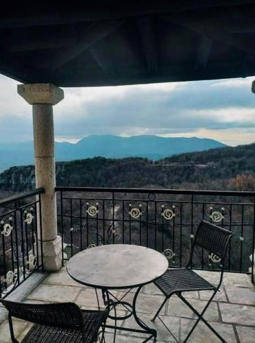 a table and chairs on a balcony with a view at Soul boutique hotel in Monodendri
