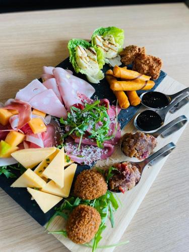 a plate of food with different types of food at Mercure Hotel Den Haag Central in The Hague