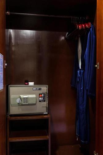 a microwave sitting on a shelf in a room at TTC Hotel - Da Lat in Da Lat