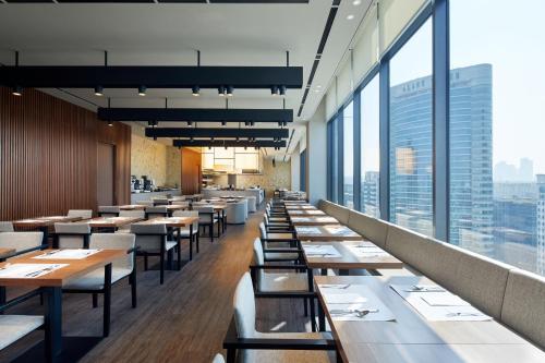 a restaurant with tables and chairs and large windows at Shilla Stay Samsung COEX Center in Seoul
