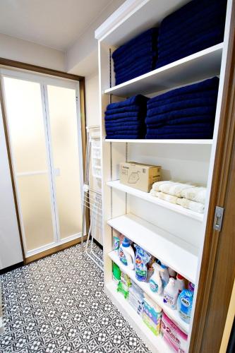 a walk in pantry with white shelves at TOMMY CONDOMINIUM WAKASA 601 in Naha