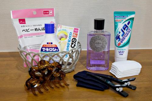 a counter with a bottle of detergent a toothbrush and cosmetics at TOMMY CONDOMINIUM WAKASA 601 in Naha