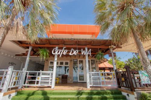 a cafe bella with palm trees in front of it at Baan Grood Arcadia Resort & Spa in Ban Krut
