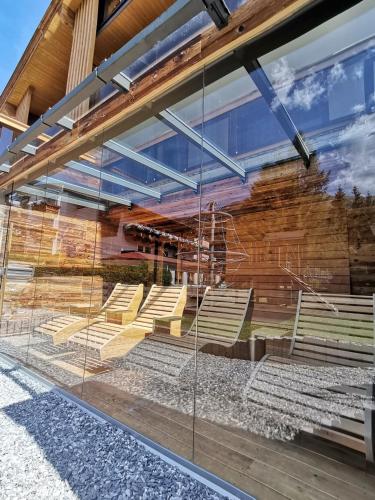 a display window of a building with benches at Hotel Alpina in Rauris
