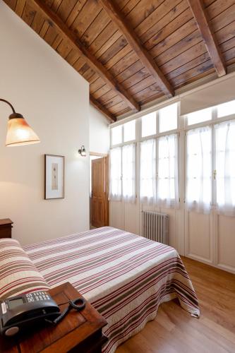 a bedroom with a bed in a room with windows at Casa Soto in Vegadeo