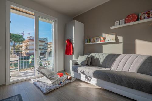 una camera con un letto e una sedia e una finestra di Babyaccommodation Family Green a Pietra Ligure