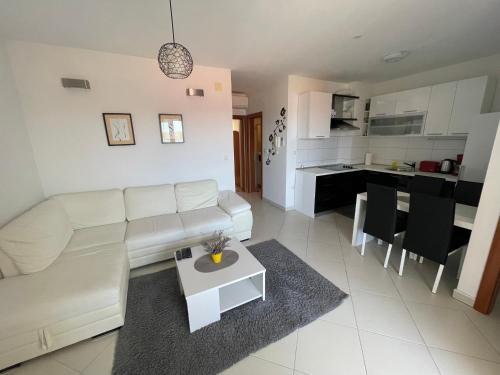 sala de estar con sofá blanco y mesa en Apartment Ana, en Trogir