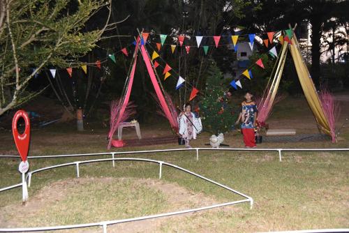 two children and a dog in a park with flags at ฺBaan Rai Ing Doi in Chaiyaphum