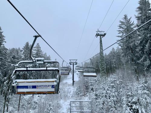 a ski lift with snow on the ground at Apartment Seeblick am Bocksberg - Hahnenklee "Vier Jahreszeiten" in Hahnenklee-Bockswiese