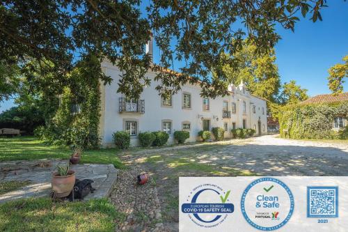 a large white house with a sign in front of it at Quinta da Torre in Torre