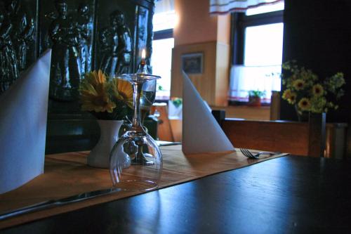 a table with a napkin and a bottle of wine and a paper at Guesthouse Jersin in Logatec