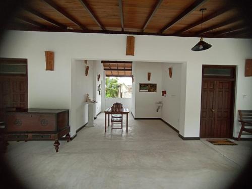 a room with a table and a chair in it at Ahangama Eco Villa in Ahangama