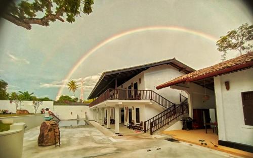 a rainbow in the sky over a house at Ahangama Eco Villa in Ahangama