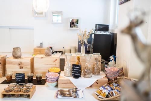a table with glass jars and other items on it at La Tgoma - Hotel & Restaurant in Lenz