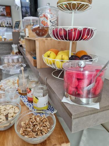 a counter topped with bowls of fruit and nuts at Tramonto Ibleo Resort in Avola