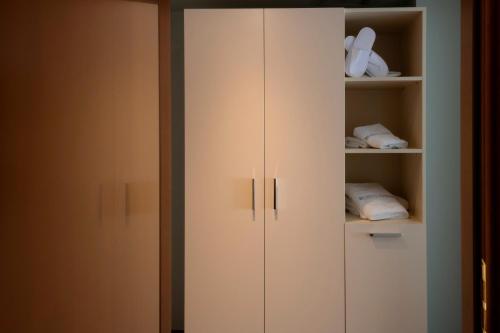 a closet with white cabinets in a room at Hotel Kierion in Kardítsa