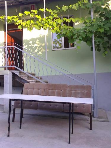una panchina seduta di fronte a una scala di Дом под ключ a Gagra